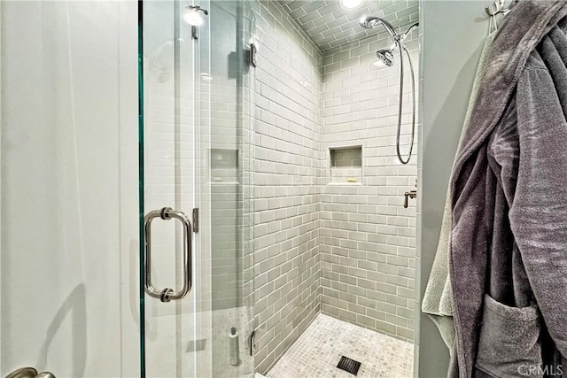 bathroom with a shower with shower door