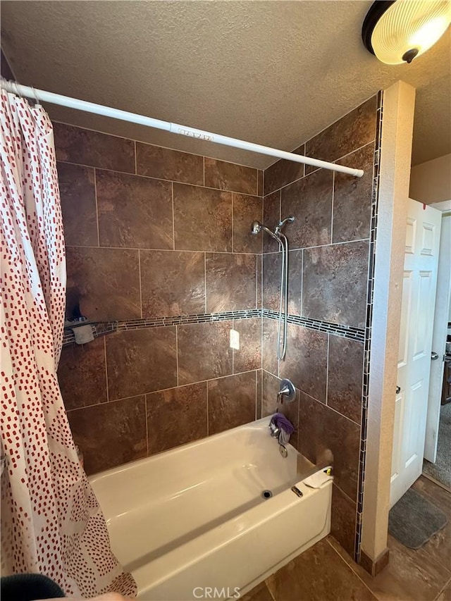 bathroom with shower / tub combo and a textured ceiling