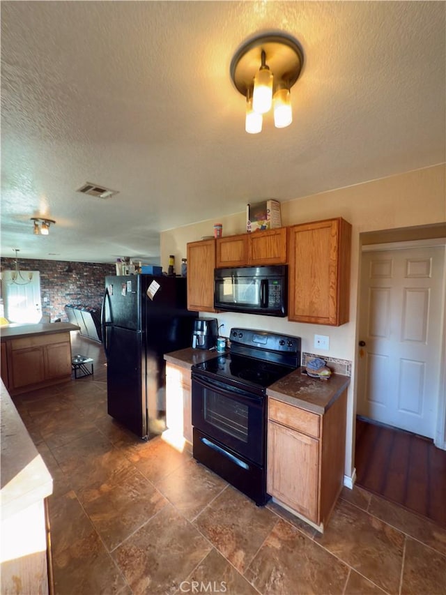 kitchen with black appliances and a textured ceiling