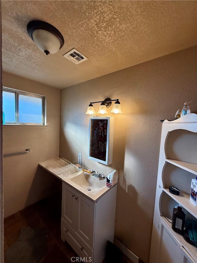 bathroom featuring vanity and a textured ceiling