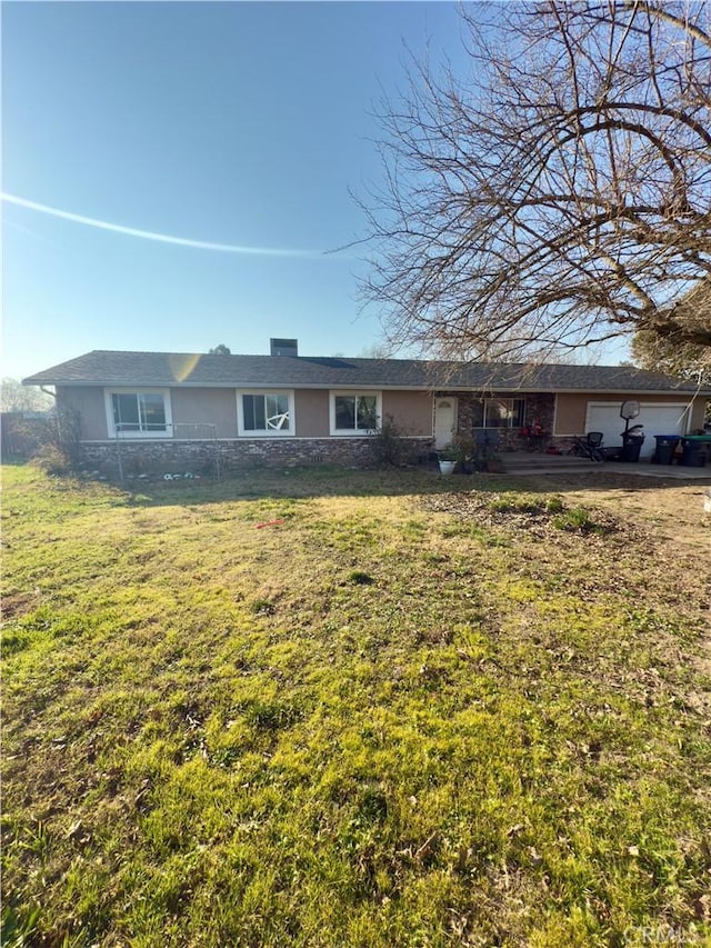 ranch-style home with a garage and a front yard