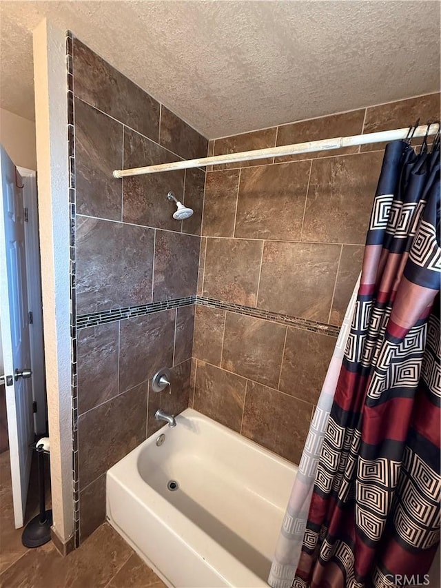 bathroom featuring shower / bathtub combination with curtain, tile patterned flooring, and a textured ceiling