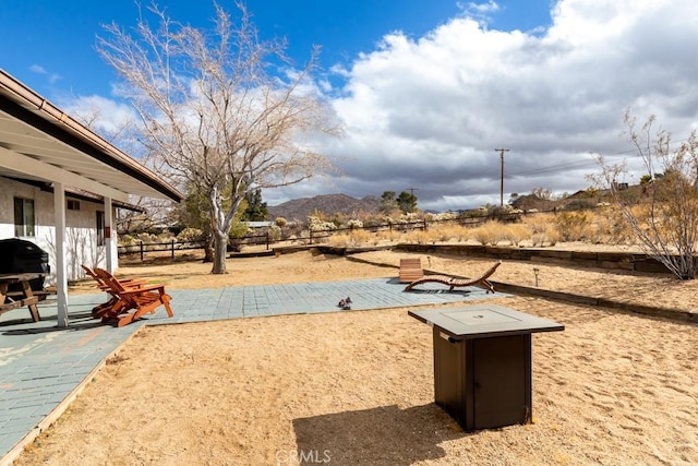 view of community featuring a mountain view and a patio area