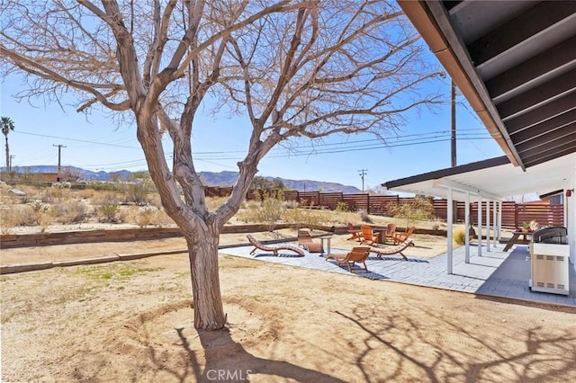 view of yard with a mountain view, a fire pit, and a patio