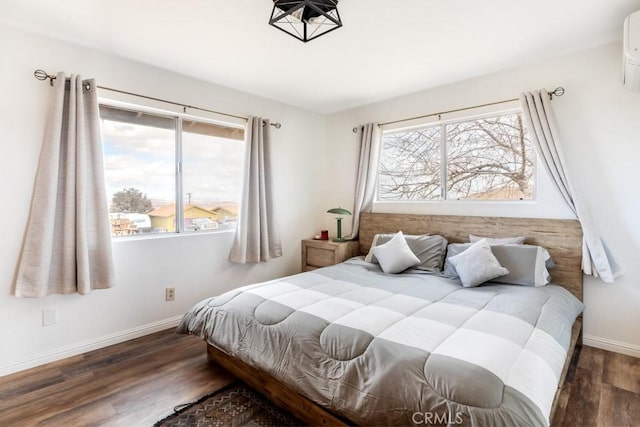 bedroom featuring multiple windows and dark hardwood / wood-style floors