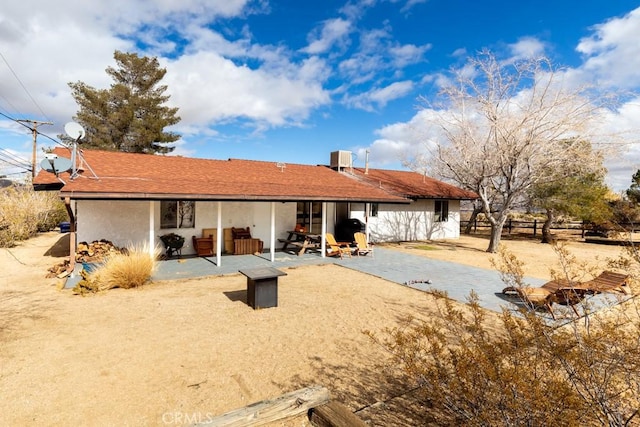 back of house with central AC unit and a patio area