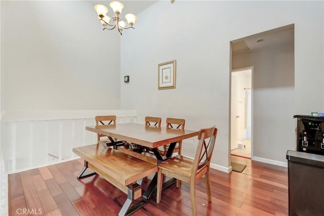 dining room featuring hardwood / wood-style flooring and a chandelier