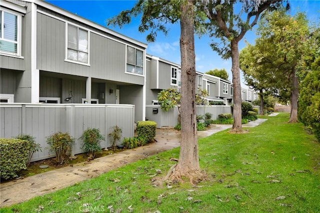 view of side of property with a yard