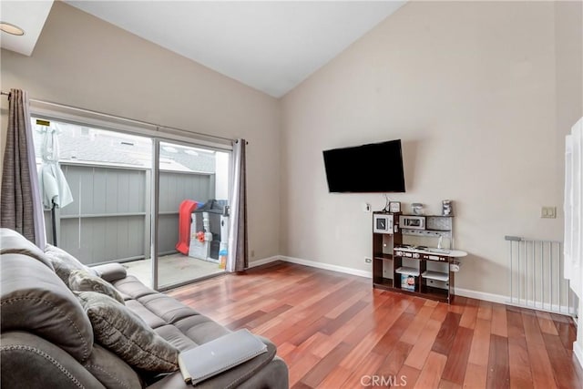 living room with hardwood / wood-style flooring and vaulted ceiling