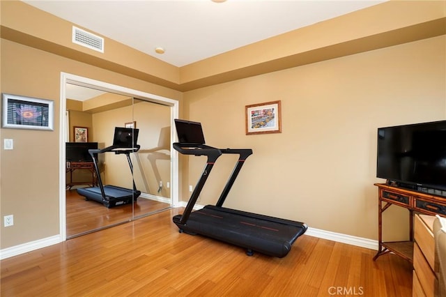 workout area with hardwood / wood-style flooring