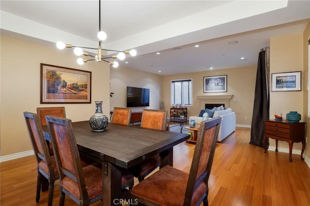 dining area with a chandelier and light hardwood / wood-style floors