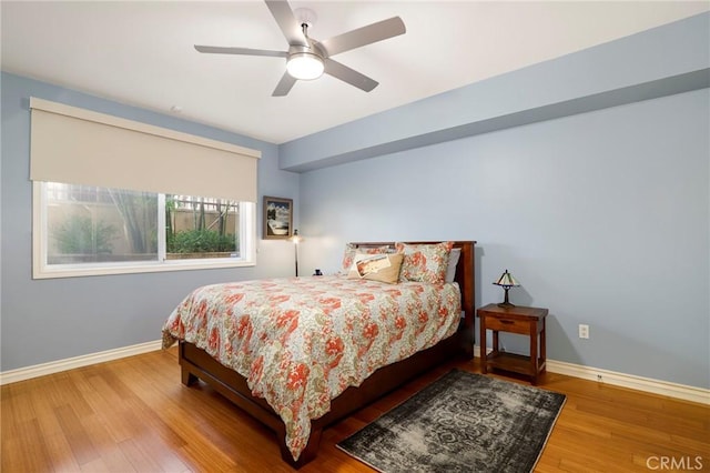 bedroom with ceiling fan and hardwood / wood-style floors