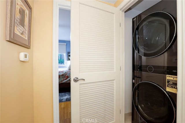 laundry room featuring stacked washer / drying machine