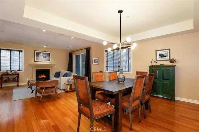 dining space with an inviting chandelier and light wood-type flooring