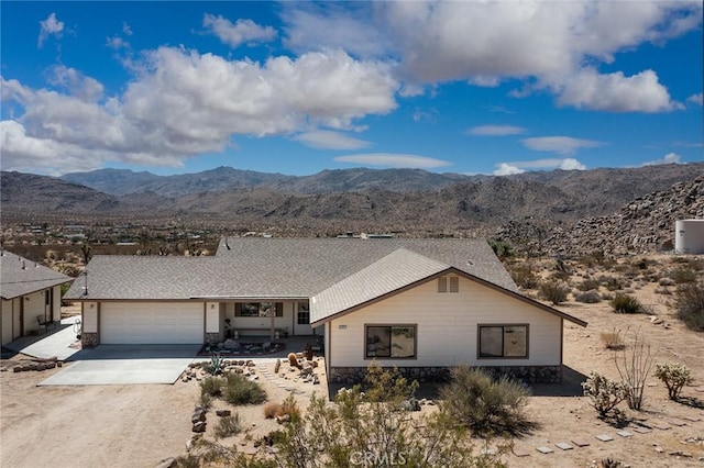 ranch-style house featuring a mountain view and a garage