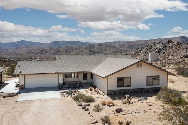 ranch-style house with a garage and a mountain view