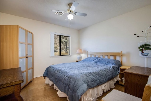 bedroom with hardwood / wood-style flooring and ceiling fan