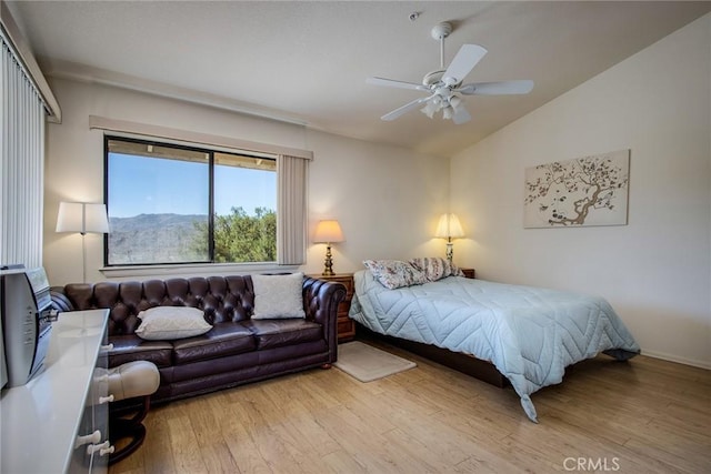 bedroom featuring ceiling fan, lofted ceiling, and light hardwood / wood-style floors