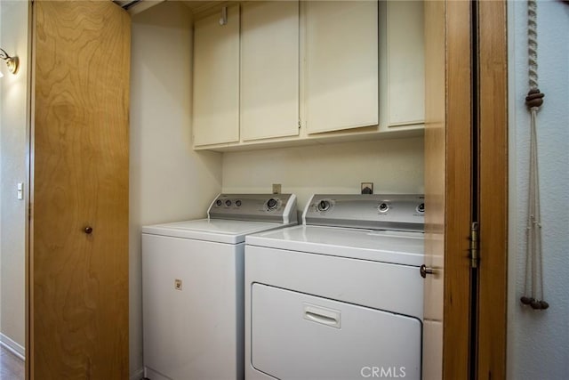 laundry area featuring cabinets and washer and clothes dryer