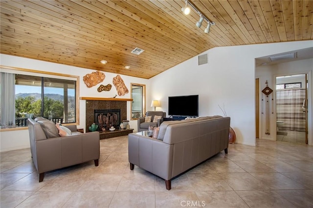 tiled living room featuring wood ceiling, track lighting, lofted ceiling, and a mountain view