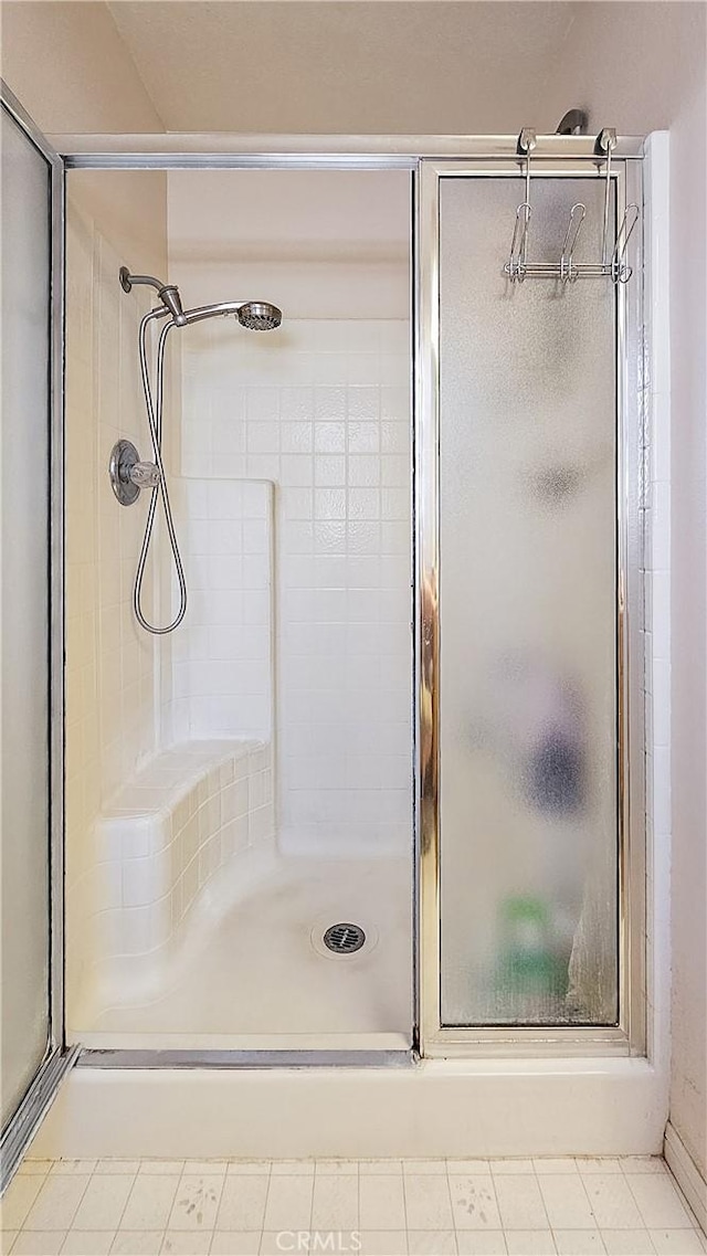 bathroom with a shower with door