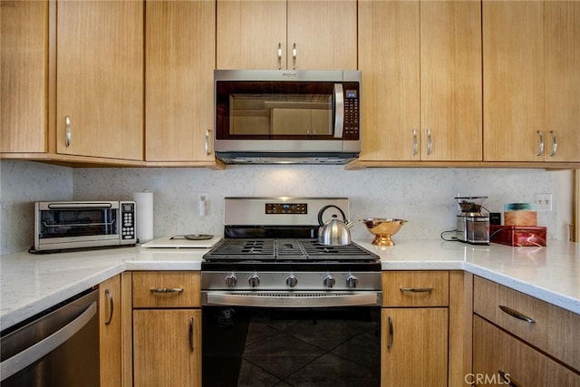 kitchen featuring tasteful backsplash and stainless steel appliances