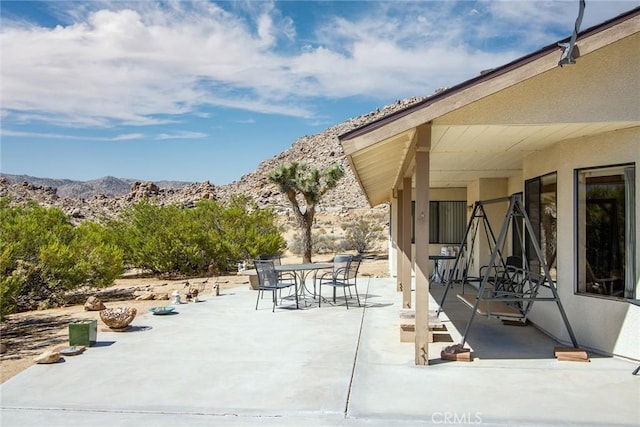 view of patio / terrace with a mountain view