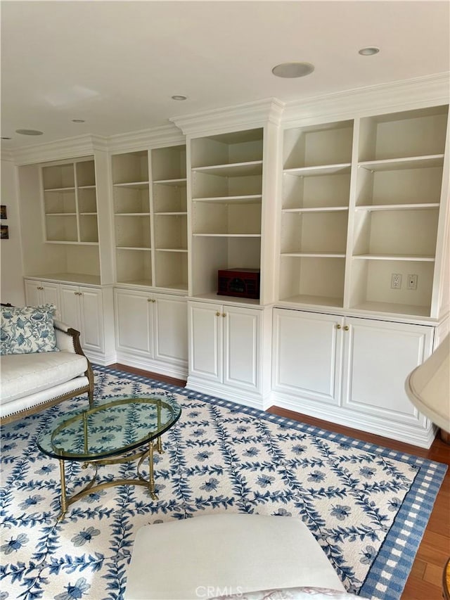 living room featuring ornamental molding and dark wood-type flooring