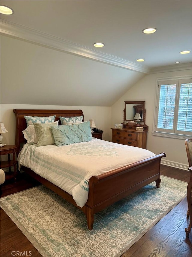 bedroom featuring crown molding, lofted ceiling, and dark wood-type flooring