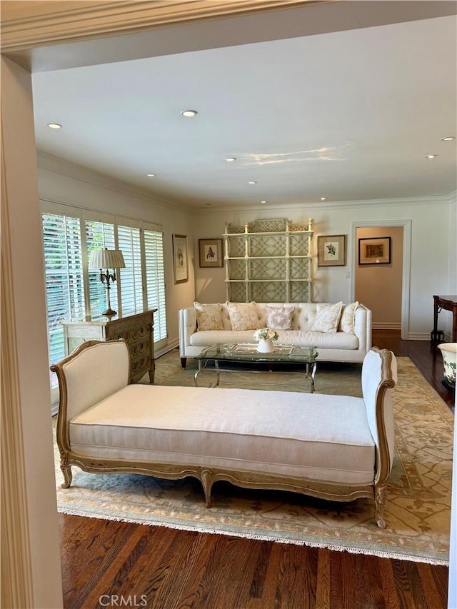 living room with hardwood / wood-style flooring and crown molding