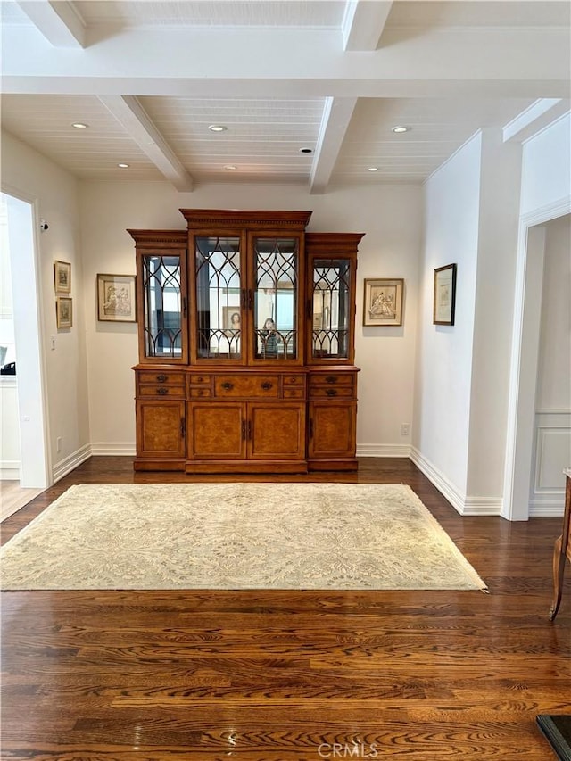 entryway with beamed ceiling and dark wood-type flooring