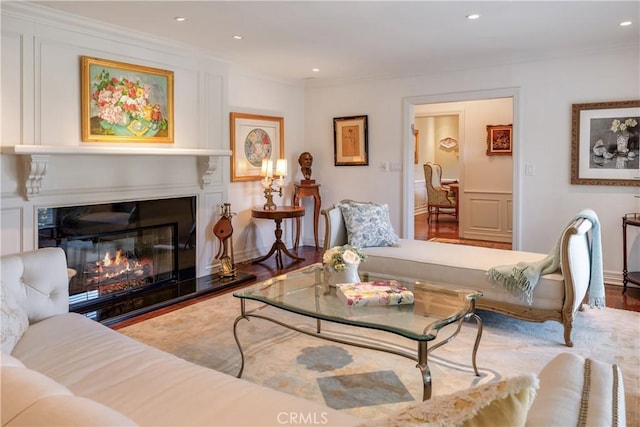 living room with wood-type flooring and ornamental molding