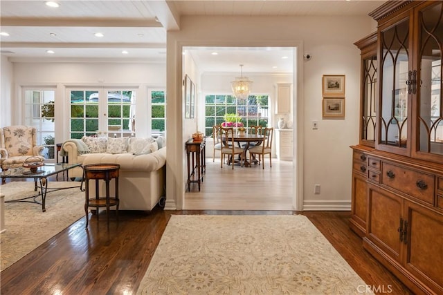 interior space with dark hardwood / wood-style flooring, an inviting chandelier, and french doors