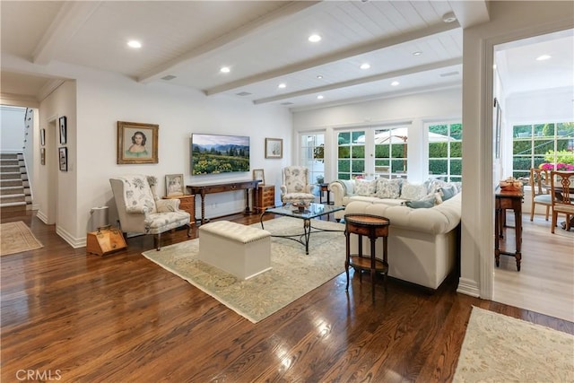 living room featuring beam ceiling and dark hardwood / wood-style floors