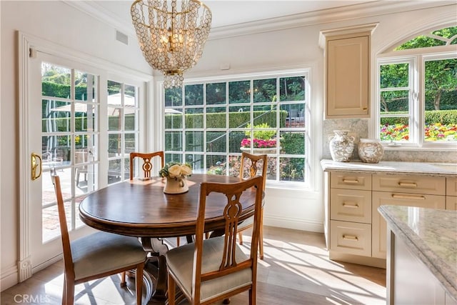 sunroom / solarium with an inviting chandelier