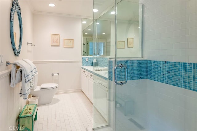 bathroom with a shower with shower door, tile patterned floors, toilet, ornamental molding, and vanity