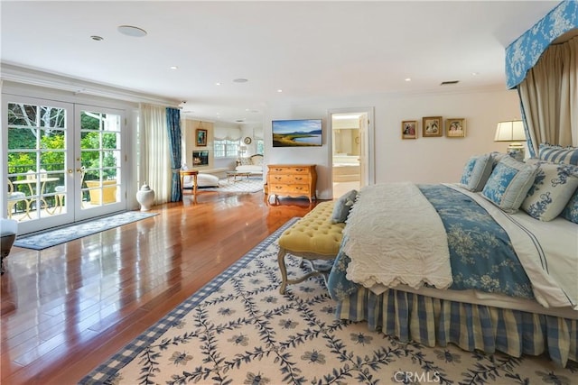 bedroom featuring wood-type flooring, french doors, crown molding, and access to outside