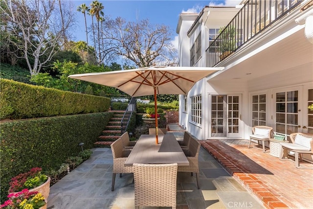 view of patio featuring french doors and a balcony