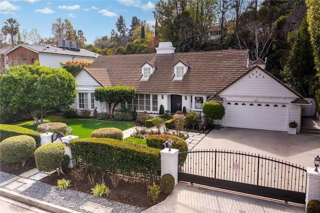 view of front of home featuring a gate, a fenced front yard, concrete driveway, an attached garage, and central AC unit