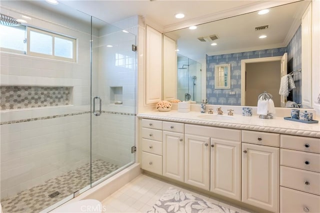 bathroom with tile patterned flooring, vanity, and a shower with door