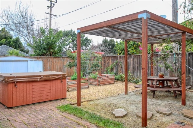 view of patio featuring a hot tub, a pergola, and a shed