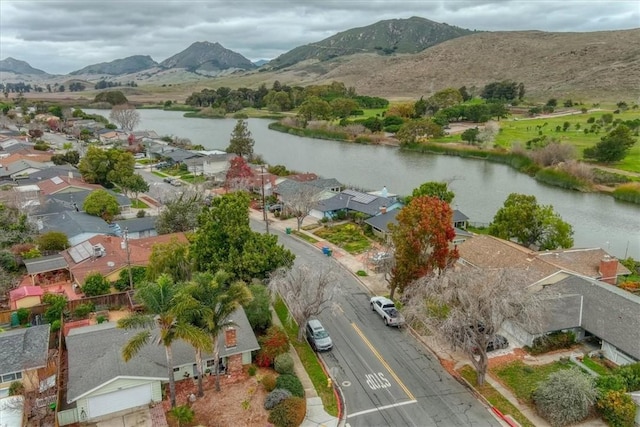 birds eye view of property with a water and mountain view