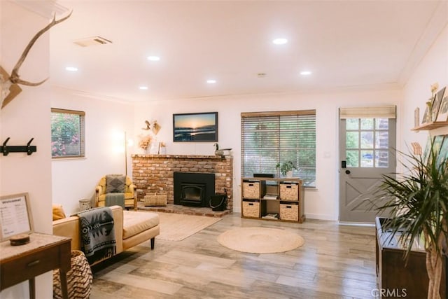 living room with crown molding and light wood-type flooring