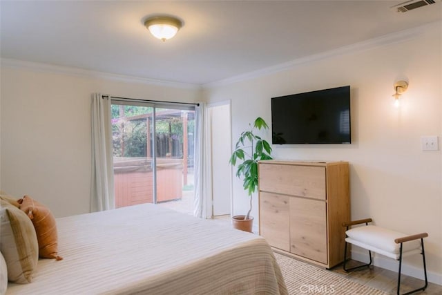 bedroom featuring ornamental molding and access to exterior