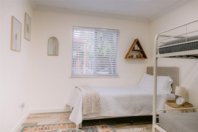 bedroom with crown molding and hardwood / wood-style flooring