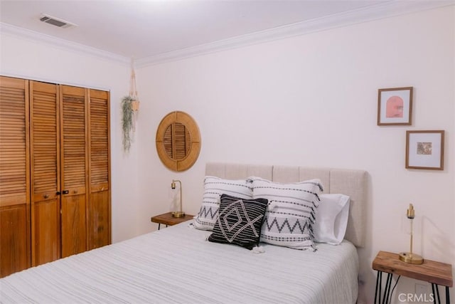 bedroom with crown molding and a closet