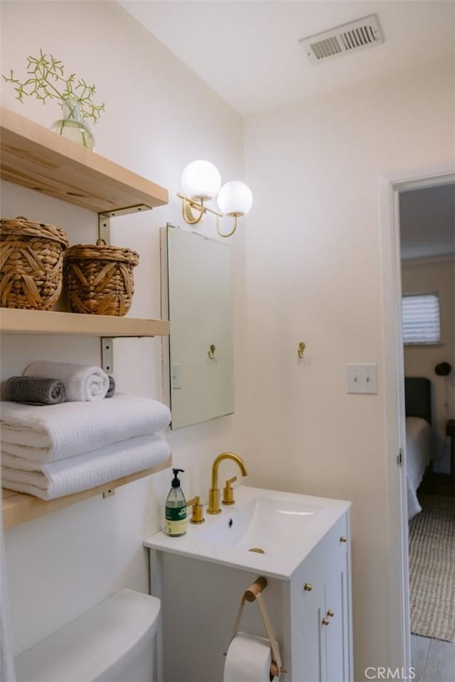 bathroom with vanity and toilet