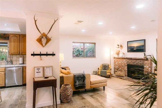 living room with a fireplace and light hardwood / wood-style flooring