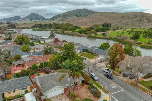 birds eye view of property with a water and mountain view