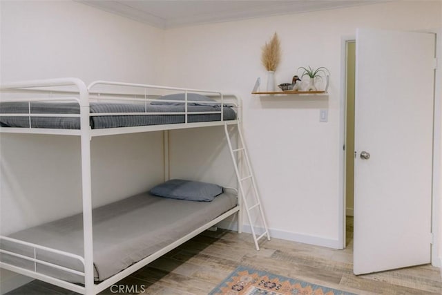 unfurnished bedroom featuring hardwood / wood-style flooring and ornamental molding